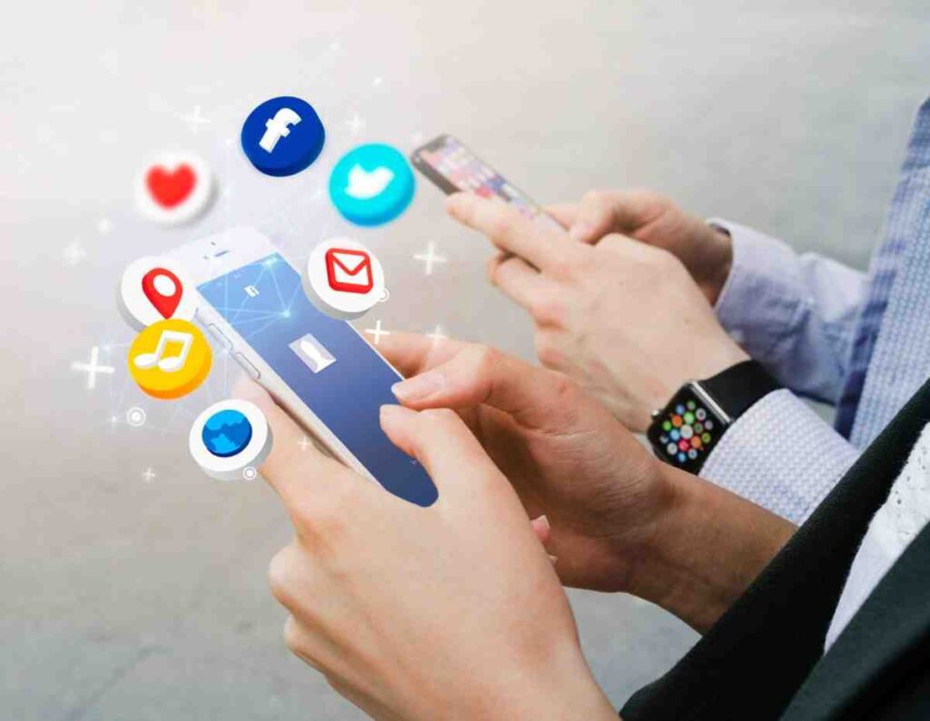 people using smartphones displaying social media icons